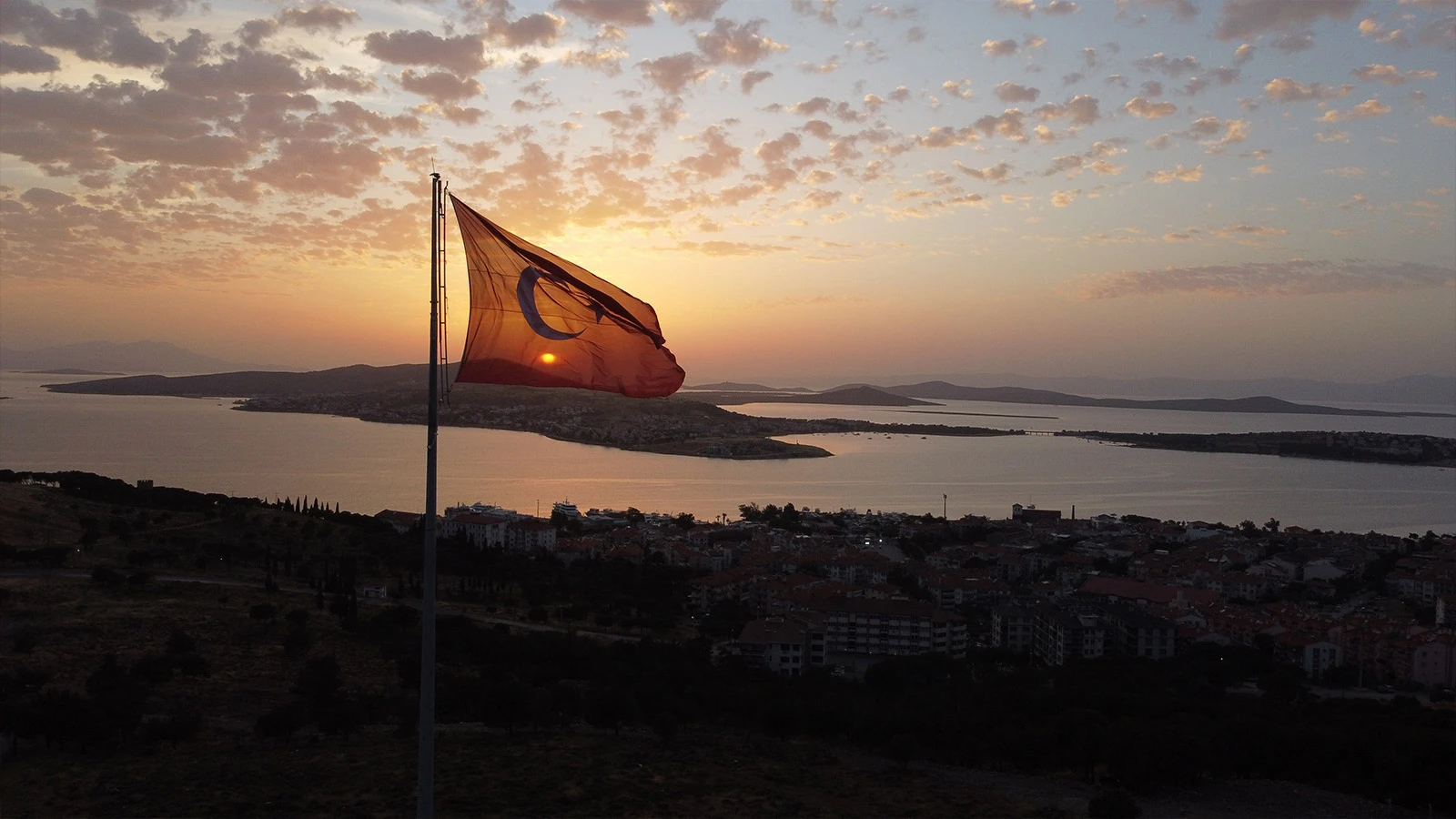 Gün batımında Türk bayrağı ve Ayvalık adalarından görsel şölen